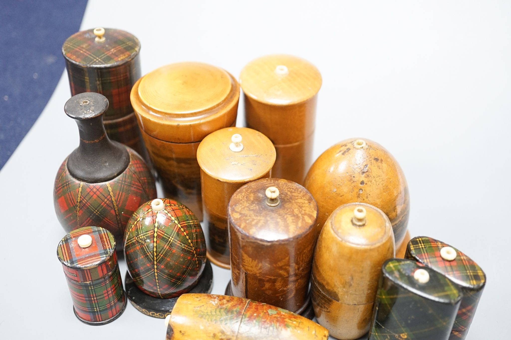 A group of tartanware, Mauchline and fern ware match holders with go-to-bed finials, and a similar tumbler case, tallest 9cm (13)